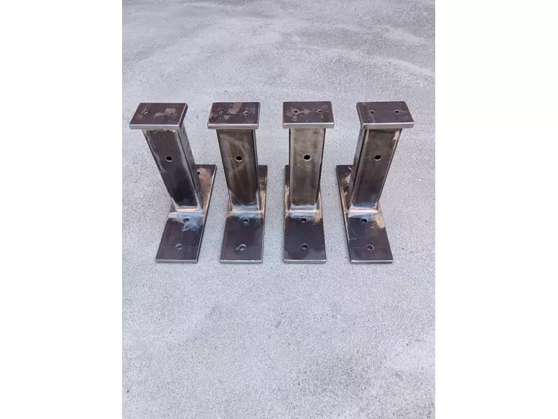 Example of welded mild-steel support brackets / mounting posts produced in small batch.  The parts consist of rectangular hollow sections, drilled base plates and top plates, welded by MIG/MAG process. Such components can be used as equipment supports, mounting brackets, auxiliary machine-frame elements or prototype support structures.  Production can be carried out according to customer drawings or technical documentation..webp